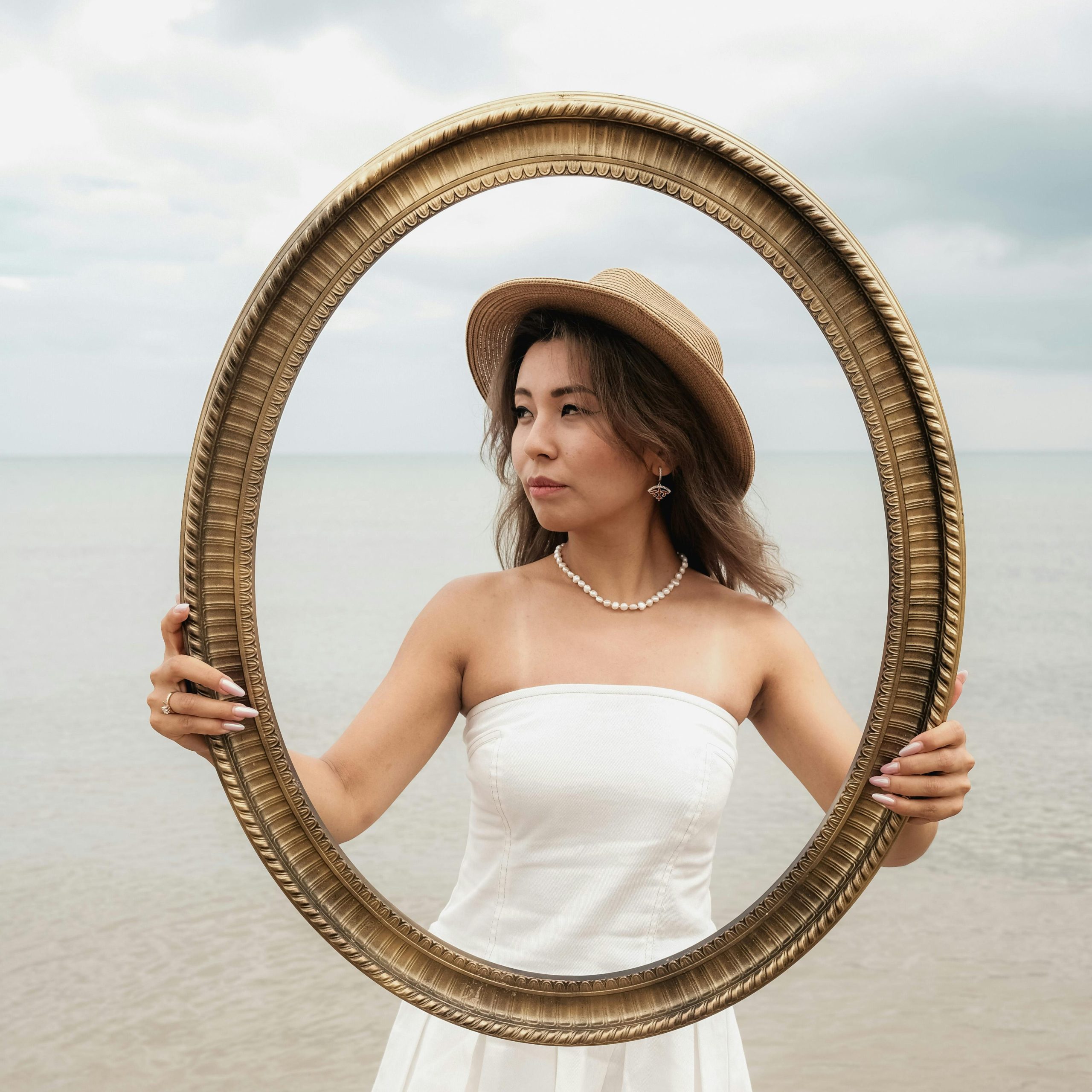 Woman holding a picture frame in front of herself