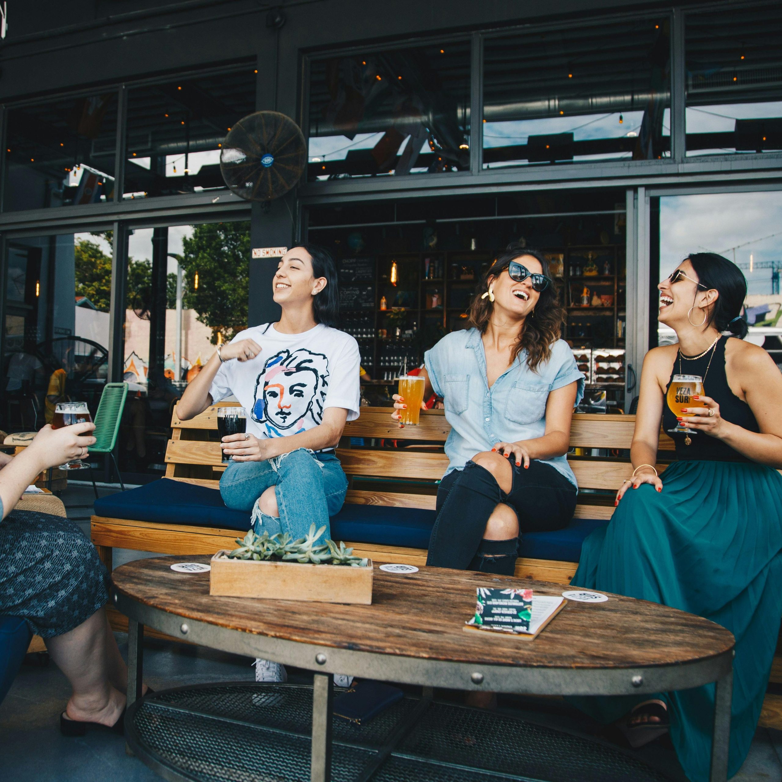 People drinking beer, chatting and laughing in a terrace