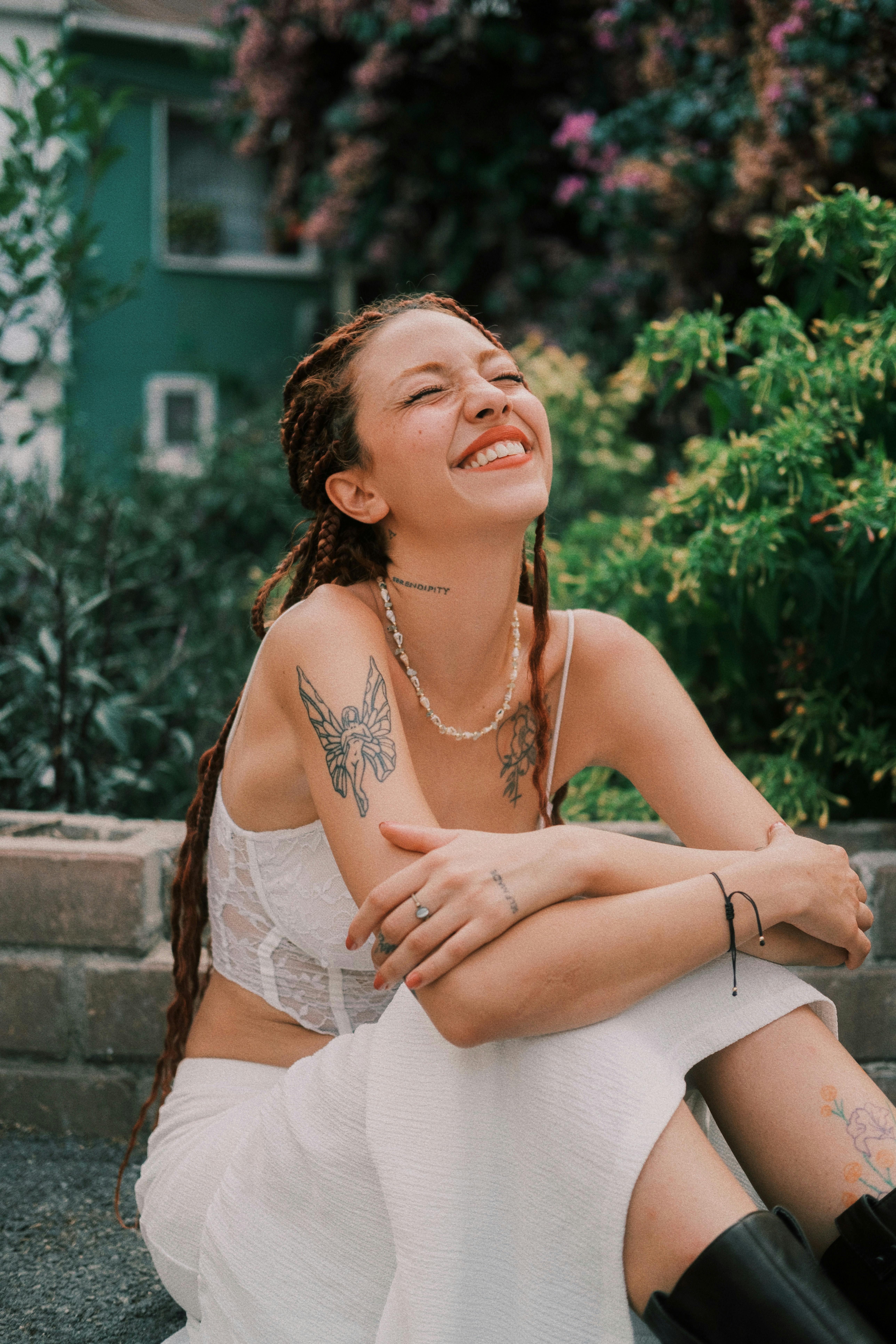 Person sitting outside, smiling, joyful